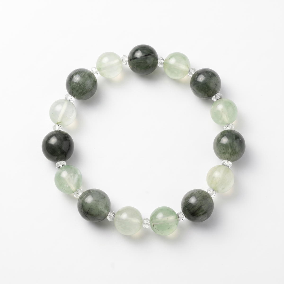 Krysora Verdant Radiance — green rutilated quartz and prehnite beads, sprouting sage green on white.