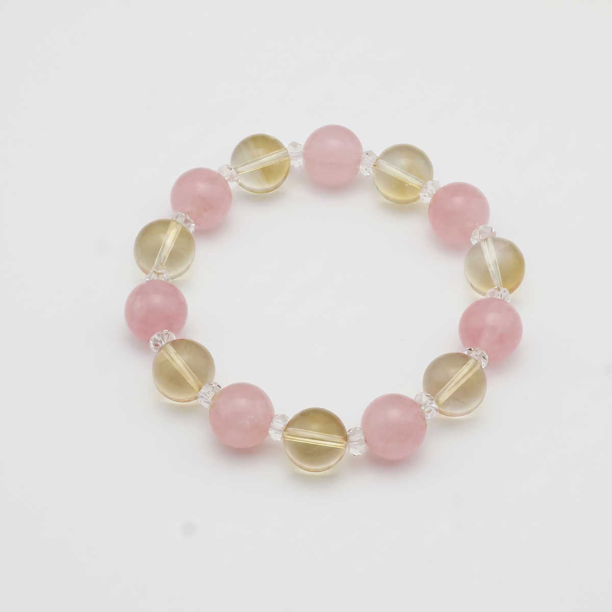 Krysora Golden Harvest — warm citrine and blush rose quartz, soft gold meeting rose on white.