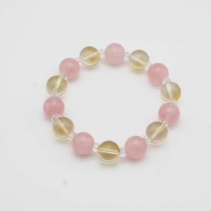 Krysora Golden Harvest — warm citrine and blush rose quartz, soft gold meeting rose on white.