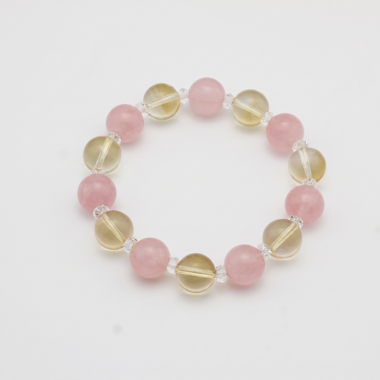Krysora Golden Harvest — warm citrine and blush rose quartz, soft gold meeting rose on white.