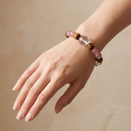 Tawny Blush bracelet by Krysora worn on a woman's wrist - warm tiger's eye with soft strawberry pink