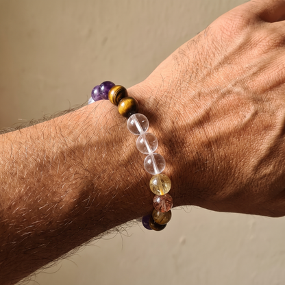 Ember Gold bracelet by Krysora worn on a man's wrist - golden-brown tiger's eye with warm red hematoid glow