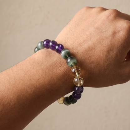 Verdant Flame bracelet by Krysora worn on a man's wrist - spring green rutilated quartz with honey gold citrine and soft violet amethyst
