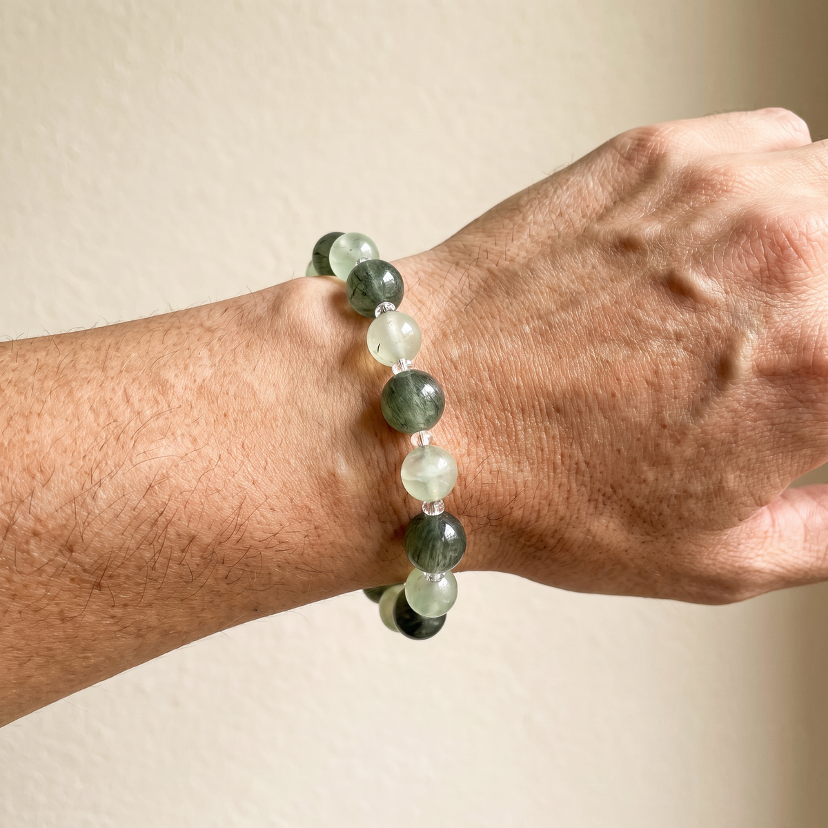 Verdant Radiance on a man's wrist — fresh sage-green rutilated quartz and prehnite.