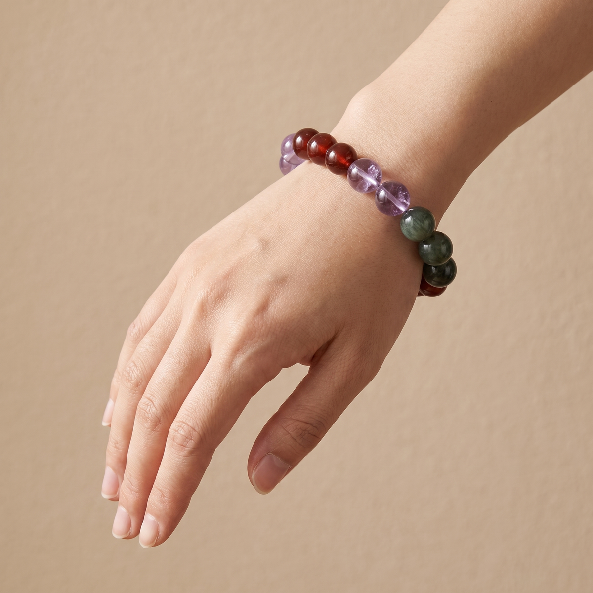 Verdant Spark bracelet by Krysora worn on a woman's wrist - sprouting green, quiet violet and warm ember beads