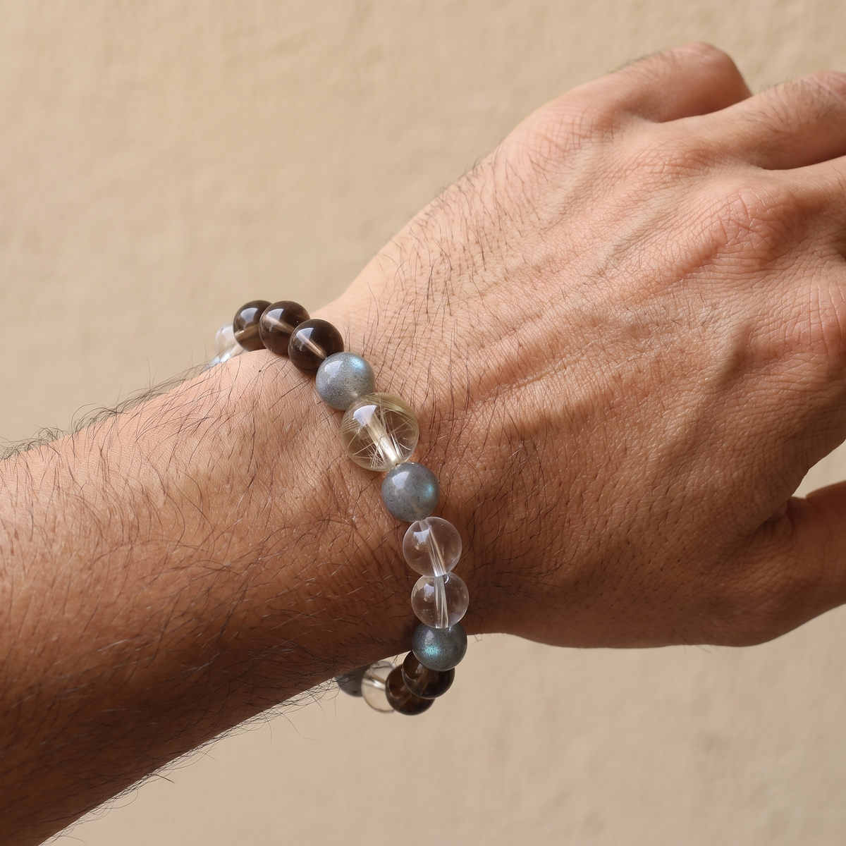 Aurum Haze bracelet by Krysora worn on a man's wrist - warm golden rutilated quartz with soft smoky brown