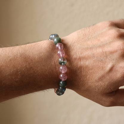 Verdant Bloom bracelet by Krysora worn on a man's wrist - clear green phantom and rutilated quartz with berry pink strawberry quartz