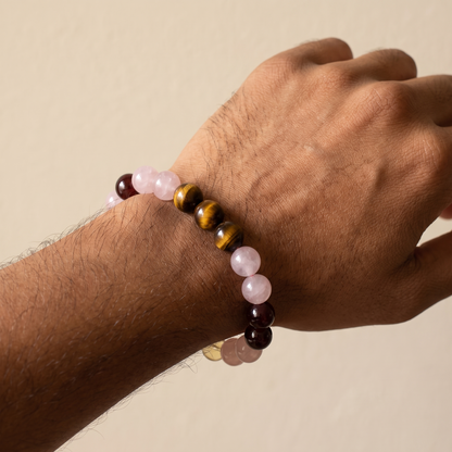 Ember Bloom bracelet by Krysora worn on a man's wrist - soft pink, golden-brown, warm red and bright yellow beads