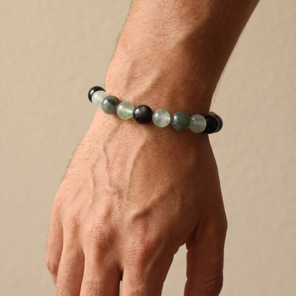 Aqua Verdance bracelet by Krysora worn on a man's wrist - cool ink and fresh sage beads with silver sheen