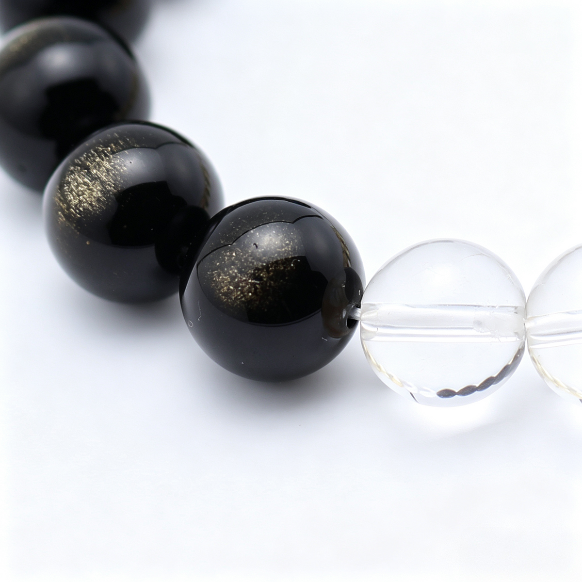 Close-up of the Terra Gold bracelet by Krysora - bead detail, golden sheen obsidian, citrine and clear quartz, natural markings