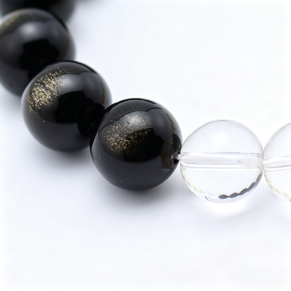 Close-up of the Terra Gold bracelet by Krysora - bead detail, golden sheen obsidian, citrine and clear quartz, natural markings