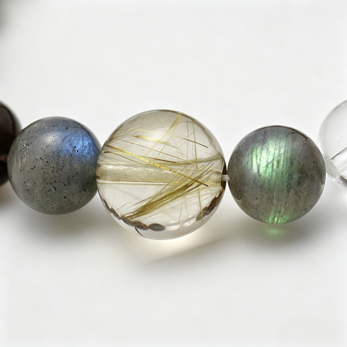 Close-up of the Aurum Haze bracelet by Krysora - bead detail, golden rutilated quartz, smoky quartz, natural markings