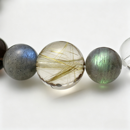 Close-up of the Aurum Haze bracelet by Krysora - bead detail, golden rutilated quartz, smoky quartz, natural markings