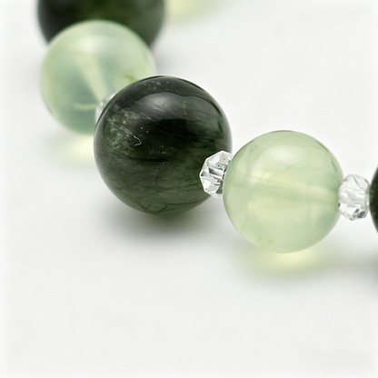 Verdant Radiance bead detail — green rutilated quartz and prehnite, natural markings up close.
