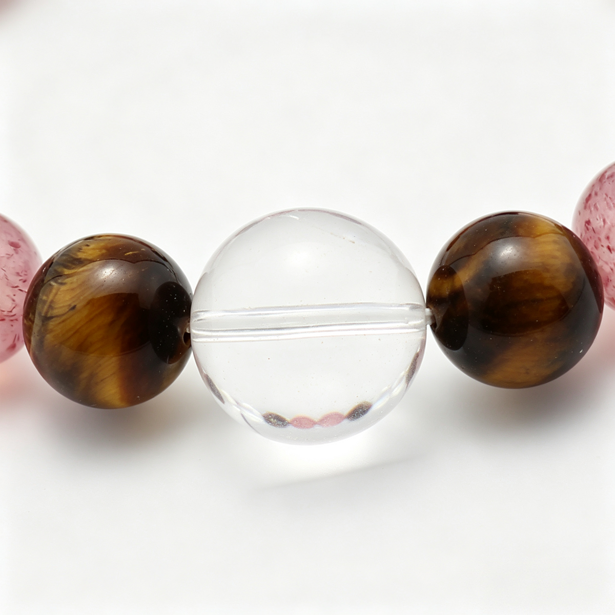 Close-up of the Tawny Blush bracelet by Krysora - bead detail, tiger's eye, strawberry quartz, natural markings