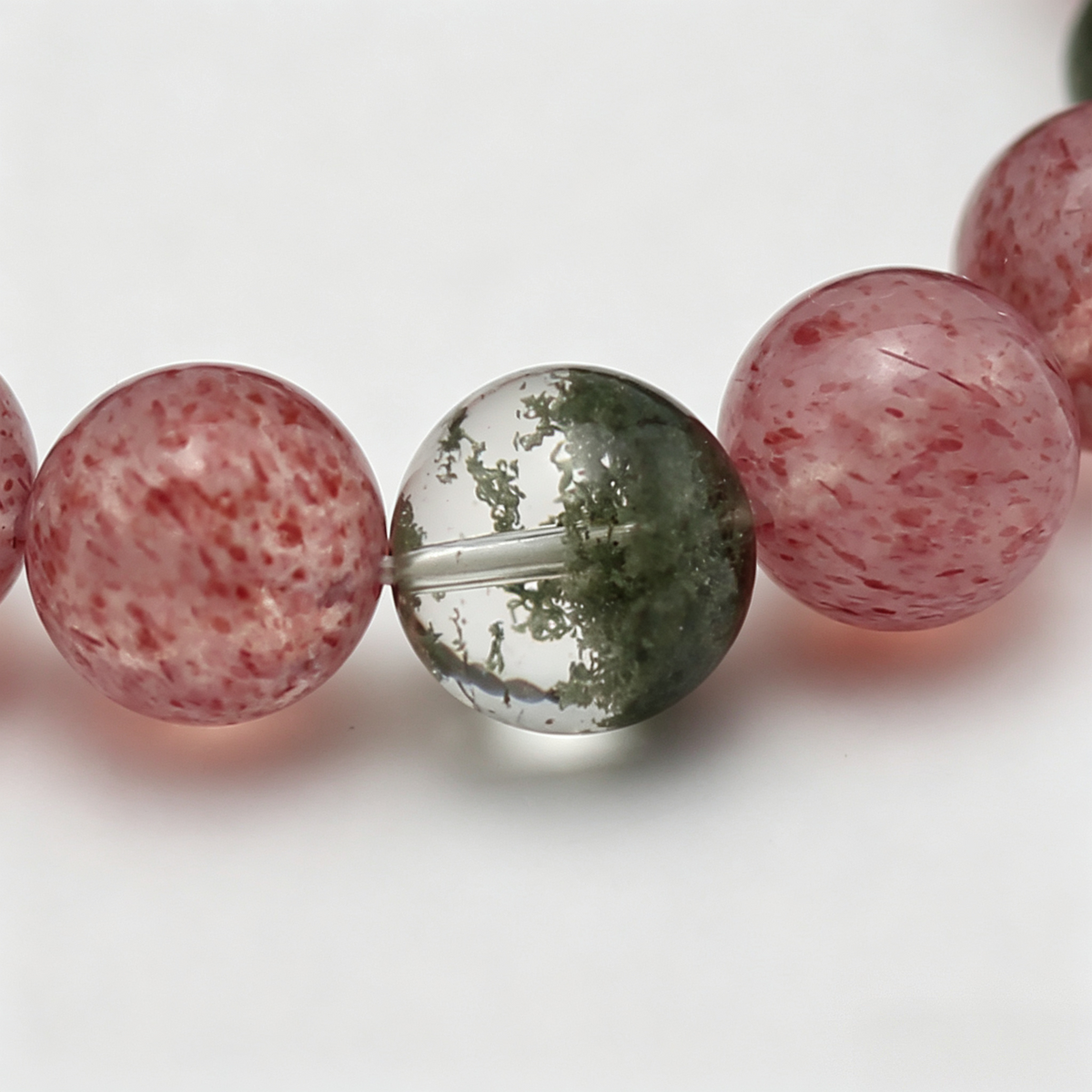 Close-up of the Verdant Bloom bracelet by Krysora - bead detail, green phantom quartz, green rutilated quartz, natural markings