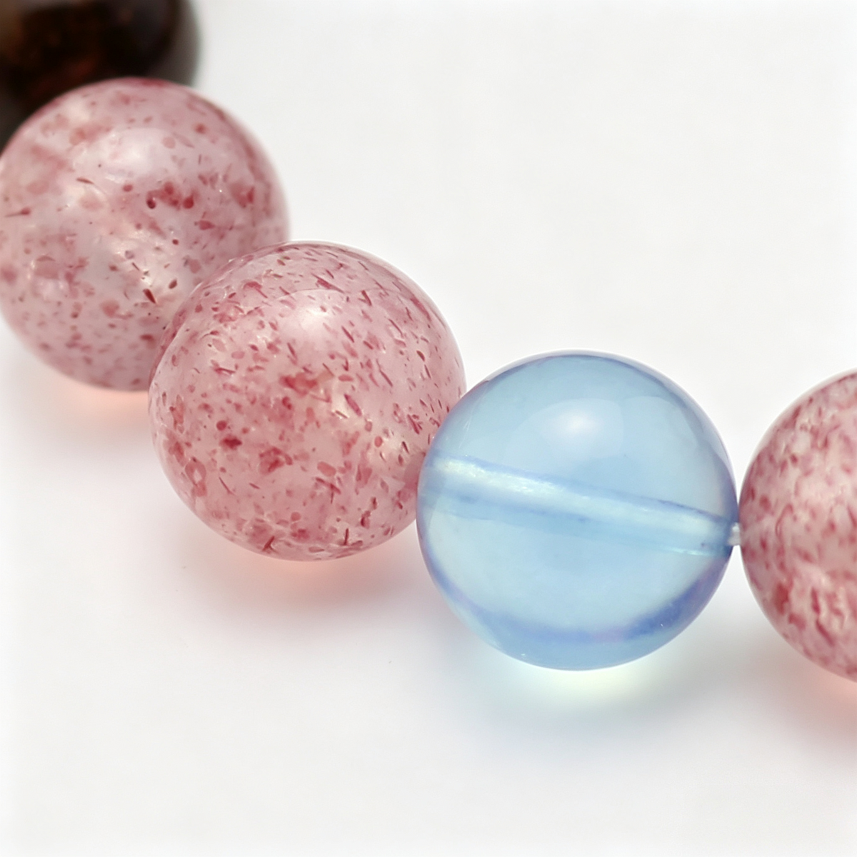 Close-up of the Tri-Sheen bracelet by Krysora - bead detail, clear blue aquamarine focal and natural markings