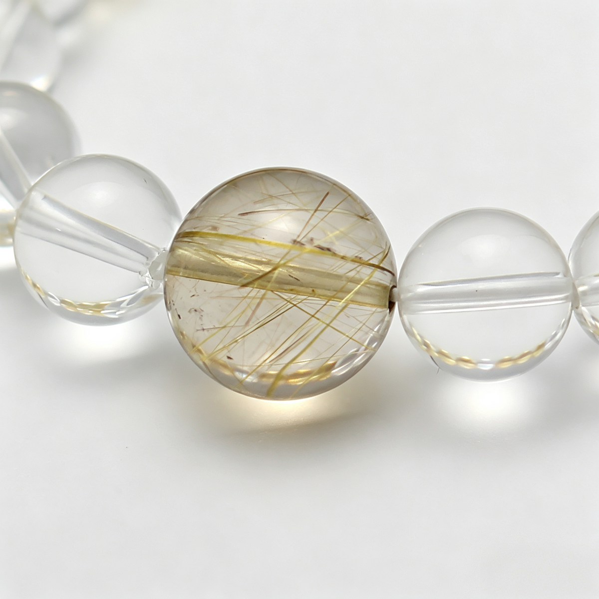 Close-up of the Gilded Radiance bracelet by Krysora - bead detail, golden needles, honey-brown citrine and warm clay tones, natural markings