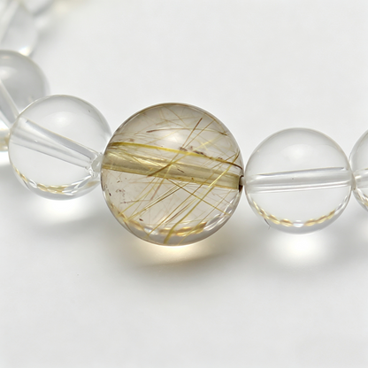 Close-up of the Gilded Radiance bracelet by Krysora - bead detail, golden needles, honey-brown citrine and warm clay tones, natural markings