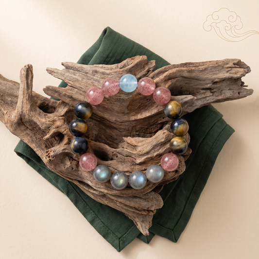 Tri-Sheen bracelet by Krysora in a brand scene - a clear blue, warm ochre, and berry-red three-tone gemstone bracelet