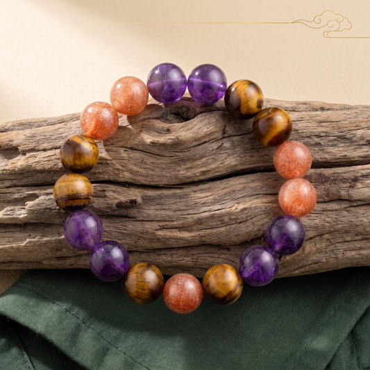 Solar Blaze bracelet by Krysora in a brand scene -- warm gold-purple amethyst, golden sunstone and tiger's eye beads, styled in natural daylight.