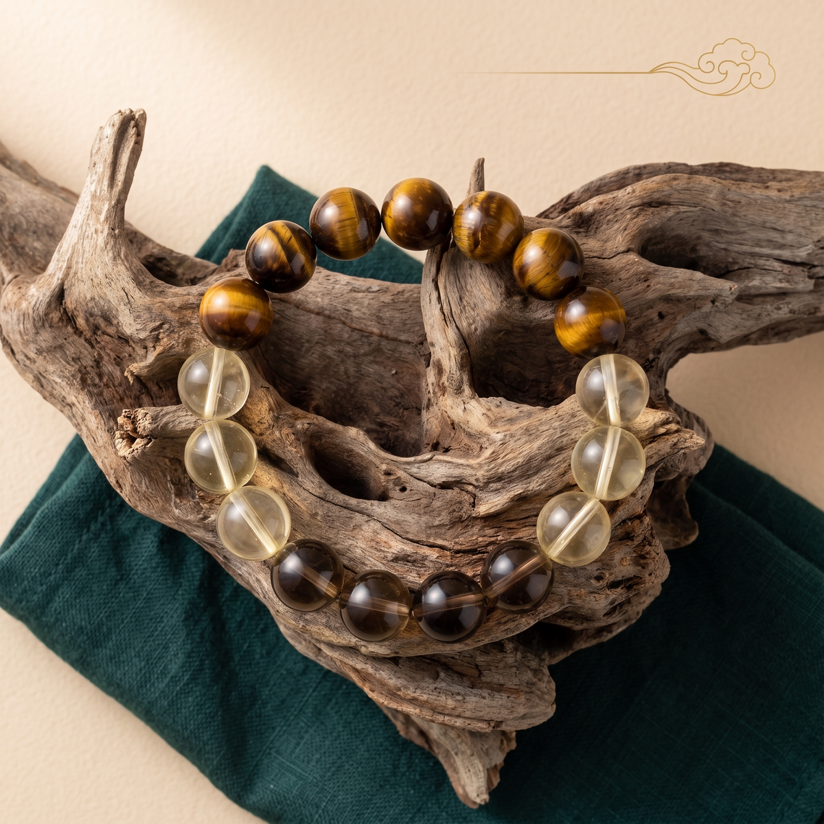 Bedrock bracelet by Krysora in a brand scene -- warm tiger's eye gold, citrine and smoky gray beads, styled in natural daylight.