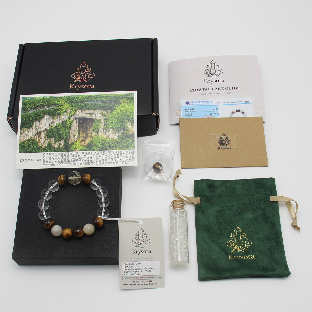 Gilded Silk bracelet by Krysora with its gift packaging - black gift box, velvet pouch, crystal care guide and certificate