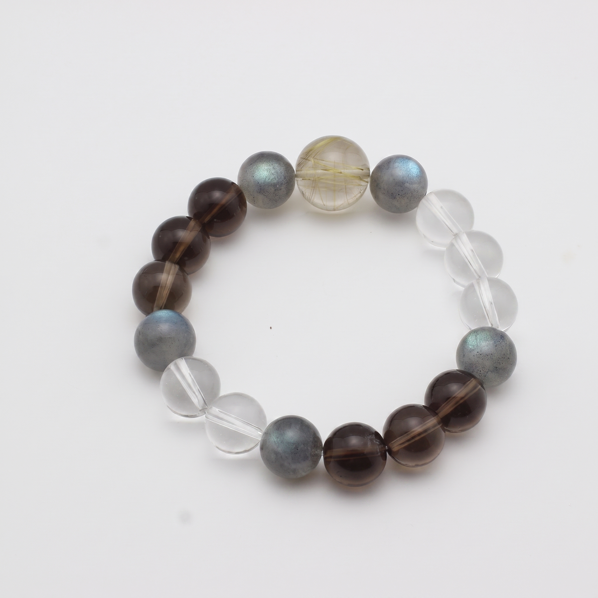 Aurum Haze bracelet by Krysora - Golden Rutilated Quartz and Smoky Quartz with Clear Quartz and Gray Labradorite, golden and brown palette, product photo on white background